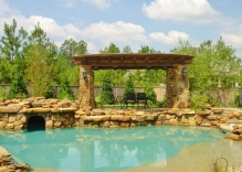 arbor-with-stone-columns-and-swimming-pool-with-cave