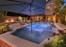 geometric pool with deck jets, tanning ledge and pool landscaping
