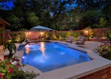 geometric pool with deck jets, tanning ledge and pool landscaping