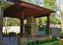 arbor-pergola-with-fire-place-and-small-flower-beds