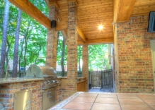 brick-outdoor-kitchen-with-stainless-steel-appliances-and-patio-cover