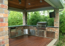 large-outdoor-kitchen-patio-cover-with-granite-counter-tops-stainless-steel-appliances-landscape-ipe-wood-decking-on-floor