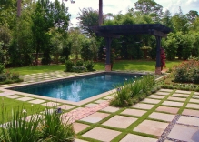 Modern-Swimming-pool-with-arbor-landscaping-flower-beds-stepping-stones