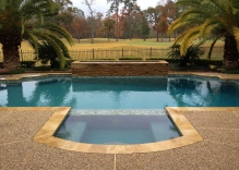 Modern-swimming-pool-remodel-with-small-water-feature-and-hot-tub