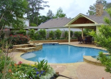 Traditional-Swimming-pool-with-small-water-feature-surrounded-by-landscape-and-patio-cover-cabana